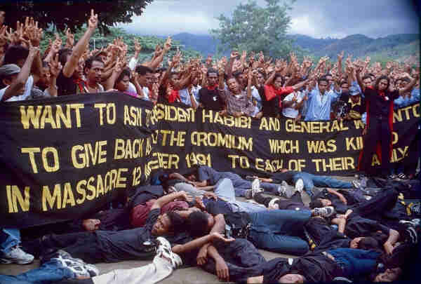 A re-enactment of the Santa Cruz massacre (in East Timor), November 1998, with people laying on the ground to portray those killed by the government. By Mark Rhomberg/ETAN - http://etan.org/etanphoto/schmid/die-in.jpg, Attribution, https://commons.wikimedia.org/w/index.php?curid=1430019