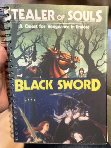 A spiral bound printout of two Stormbringer scenarios. The cover is an amalgam of the two original books. The top says “Stealer of Souls” and has a pale rider on a horse in a forest with a frightened looking person to the right. The lower says “Black Sword” and shows an armoured woman fighting the pale figure who bears a scimitar. It’s night time and towers with lights are in the background with a starry night. 