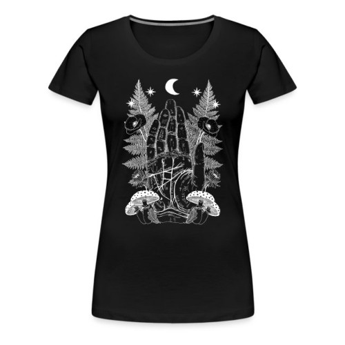 A black fitted T-shirt with a white illustration on the front. The illustration is of a detailed palmistry hand. There is a fern, a poppy, and aster, two fly agaric fungi, and an oak leaf on either side. Across the top is an arch of stars with a crescent moon in the middle.