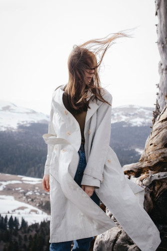 Windswept woman up in the mountains, with her hair blowing everywhere