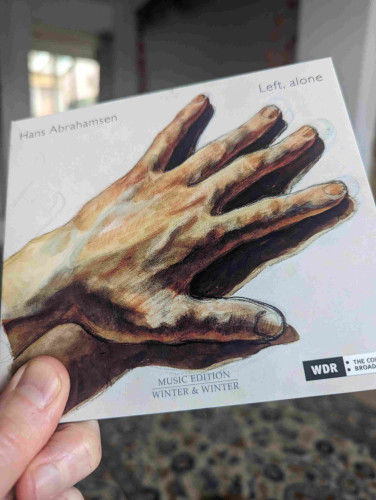 The cover of the CD. A painting of a left hand.