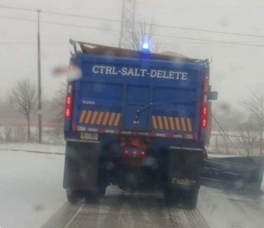A photo of the rear of a blue snow plow with the name CTRL-SALT-DELETE