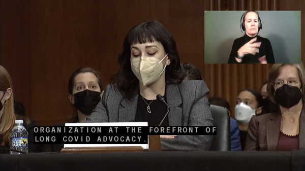 Senate hearing with speaker and audience all wearing high quality masks.