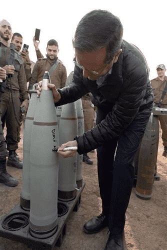Herzog, not genociding. 

Herzog signing a bomb "I'm counting on you"  in front of a group of IDF soldiers.