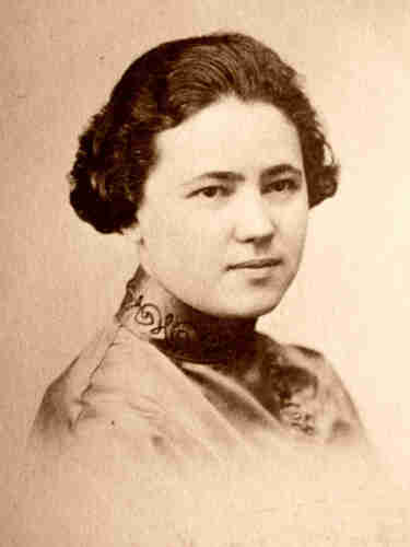 Photograph of a young Mollie Steimer, not smiling, with short, dark hair.
