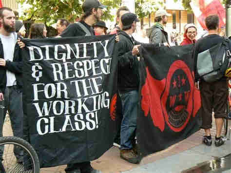 Bay area IWW holds banner at march. 