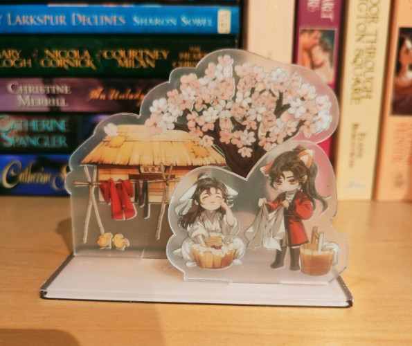 The little plastic standee, showing two long-haired men in old-fashioned robes in front of a small hut and a cherry tree. They're doing the washing, and there's also a clothline in the background.