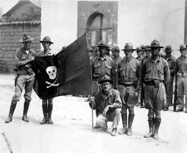 United States Marines with the captured black, skull and crossbones flag of Augusto C. Sandino in 1932. By Unknown author - http://www.defenseimagery.mil/imageRetrieve.action?guid=f13c8d13d7a7165091d1a7609e56b7fe23805946&amp;t=2, Public Domain, https://commons.wikimedia.org/w/index.php?curid=25494170