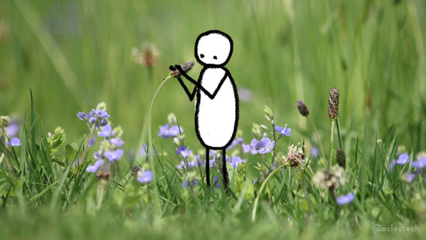 A photo of an un-mown lawn, with the focus tight across a central strip highlighting different grasses and purple flowers. Both the foreground and background are blurred. One grass with a seed head is bent over slightly, and made me think of a microphone on a stand at a gig, so I've drawn a simple wee figure testing it.