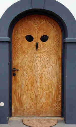 a large wooden door carved like an owl