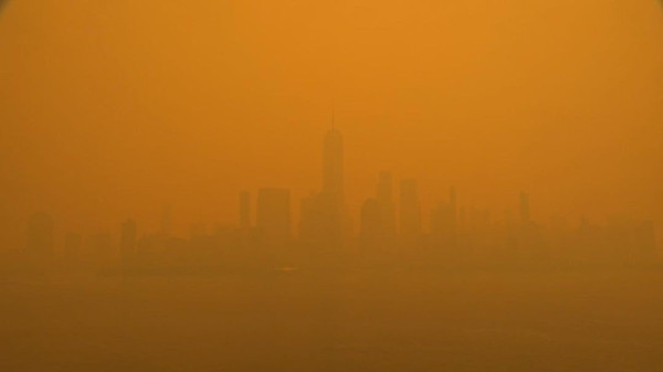 New York City's skyline on June 7, 2023, covered in orange wildfire smoke.
