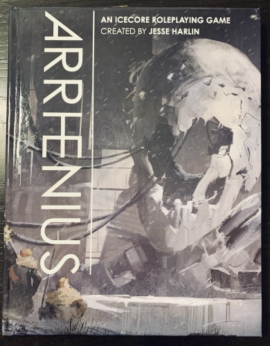 The first print copy of my TTRPG, Arrhenius, sits on a tabletop. 