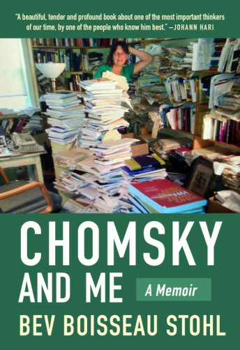 Bev Stohl standing to the side of Noam Chomsky's desk. The desk is covered with piles of books and other types of reading material, and there's a lot of books on two walls behind her. She looks relaxed in spite of the chaos, which does say a lot about her working life, in the middle of all the love that her book exudes.