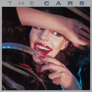 The Cars debut album. For many groups, this would be a Greatest Hits album.

Picture of a red lipsticked woman, holding her arm over her forehead, the other hand on a steering wheel.