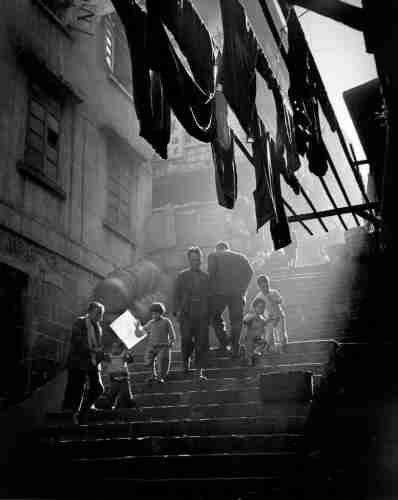 Black and white photograph of people on stairs, probably in Hong Kong.