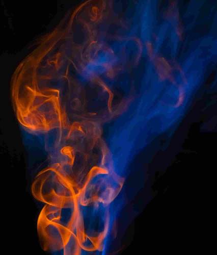 Two smoke streams on a black background. There is a blue wispy one and an orange crisp one. 