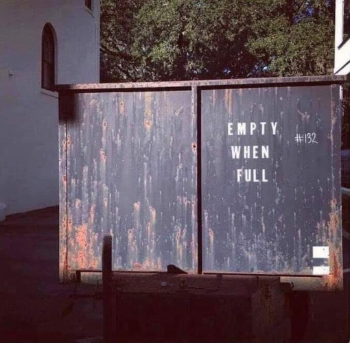 Dumpster with "Empty When Full" written on the side.
