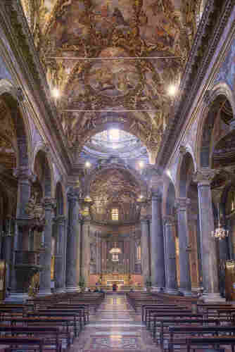 A view down the main aisle of a Baroque church in Palermo Italy: San Giuseppe dei Teatini. 
