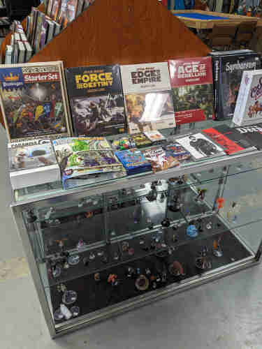 Display of RPG game books and miniatures from the local game store Comic World and Games in Dubuque Iowa.