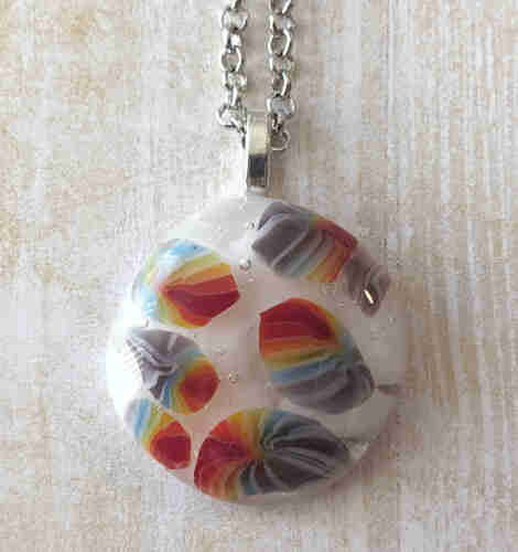 pendant with white background and rainbow foreground 