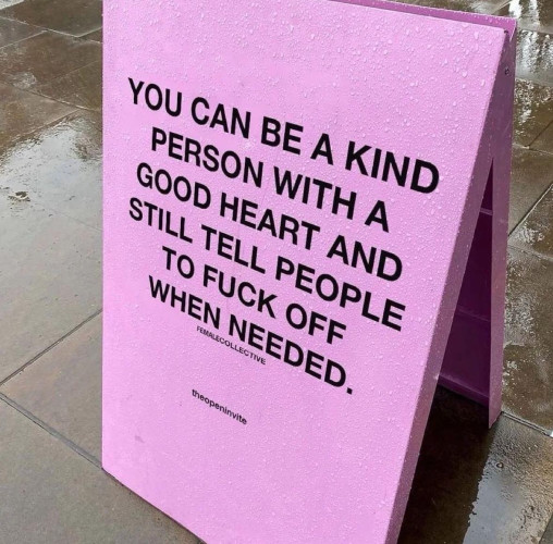 A pink “sandwich board” sign in the sidewalk with all caps letters that read: 

You can be a kind person with a good heart and still tell people to fuck off when needed. 