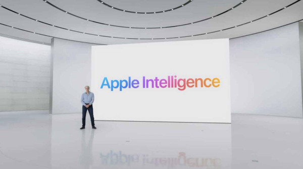 Tim Cook standing in front of a white screen with colored letters saying apple intelligence