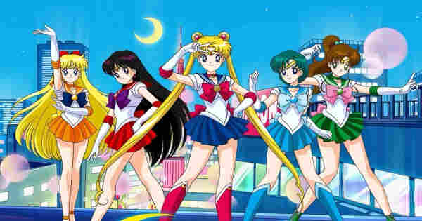 Group shot of sailor moon characters. 

Blue city night skyline in background, crescent moon overhead. 

Sailor Venus, orange skirt and blue bow. 

Sailor Mars, red skirt and purple bow. 

Sailor Moon, blue skirt, mauve bow and boots. 

Sailor Mercury, blue skirt and cyan bow. 

Sailor Jupiter, green skirt and pink bow. 