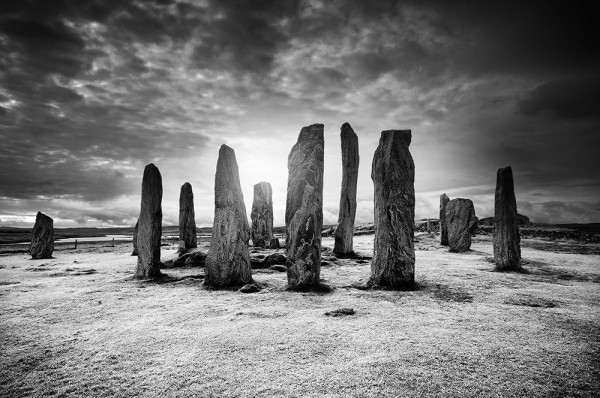 Black and white photo of the standing stones forming the circles and alignments at Callanish, on the Isle of Lewis.