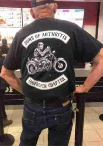 Man wearing biker shirt with skeleton on the bike. It reads (as Sons of Anarchy parody) , Sons Of Arthritis, Ibuprofen Chapter