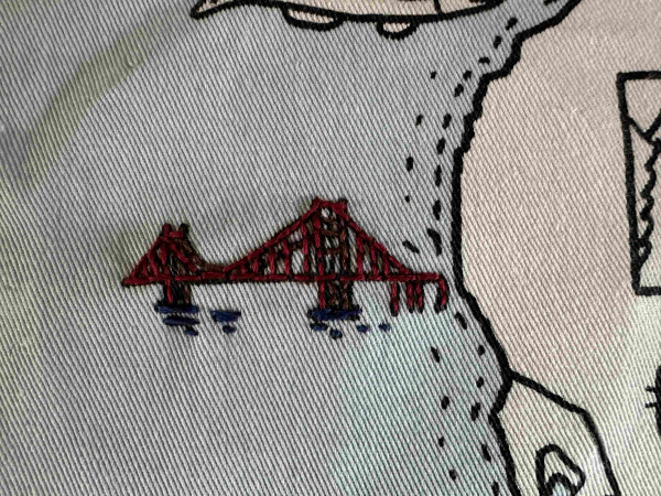 Small embroidered Golden Gate Bridge, but in dark red. 