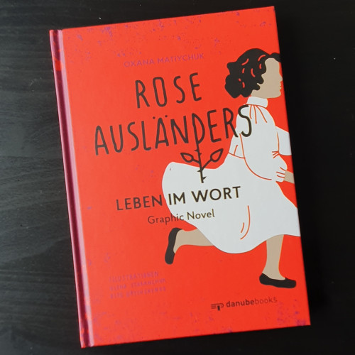 A graphic novel cover "Rose Ausländer - Leben in Wort" - all red, a girl in white running off the cover. 