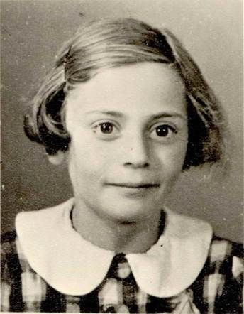 Vintage black-and-white photo of a girl, featuring her wearing a collared, striped dress and looking directly at the camera with a slight smile.