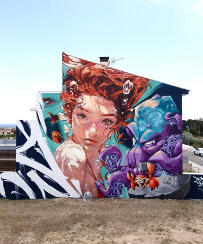 Streetartwall. The mural of a young girl underwater was sprayed/painted on the exterior wall of a two-story modern building with only one pitched roof. The bright face of the red-haired girl is surrounded by blue water, red fish and air bubbles. She is submerged and encounters a wild looking purple octopus and a funny red crab sprayed to her right. A great mural with urban style and mixing elements of Graffiti for a strange and narrow terraced house.