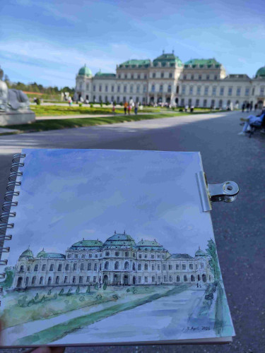A ink and watercolor sketch of Belvedere Palace, a baroque palace in Vienna. The real palace is in the background. The weather is sunny and a lot of people hang out in the palace gardens.