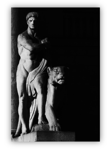 Neoclassical sculpture of a man with a lioness.