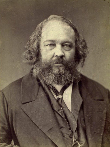 An older Bakunin, with long, wavy gray hair and long, gray beard. By Nadar - The New York Public Library [1], Public Domain, https://commons.wikimedia.org/w/index.php?curid=3984624