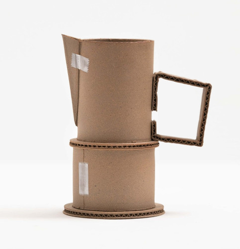 a pitcher-esque ceramic vessel that appears as if it was made from cardboard