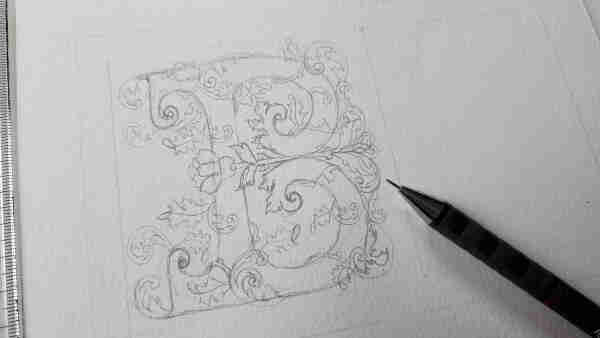 Pencil sketch of the letter B with swirling vines and leaves surrounding it