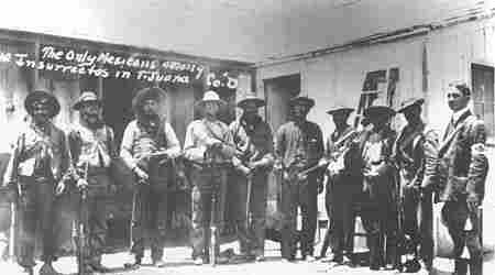 Magonist guerrillas of Mexican origin in the capture of Tijuana, with rifles, bandoliers and broad-brimmed hats. By http://www.sandiegohistory.org/journal/99winter/images/p15z.jpg, Public Domain, https://commons.wikimedia.org/w/index.php?curid=2615078