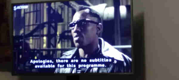 Photo of Blade 2 on TV. Blade is saying something, but the subtitles read "Apologies, there are no subtitles available for this program."