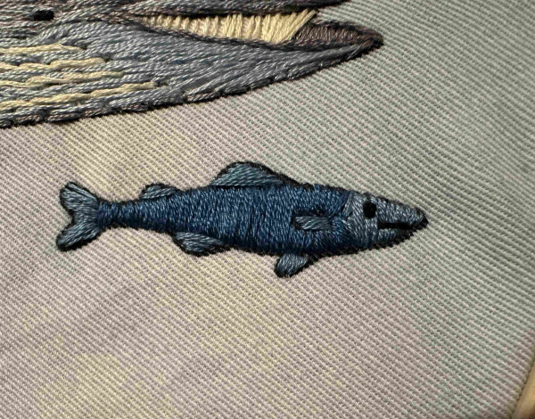 A small blue embroidered fish 