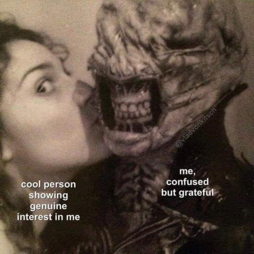 Still image. Person kissing a Hellraiser-style body-horror figure with no eyes or lips, maw wide open showing teeth and jaws. Kissing person is labeled "cool person showing genuine interest in me", other figure labeled "me, confused but grateful"