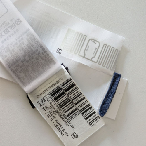 Photo of cut off RFID tags in underwear with bar codes and visible RFID tag.