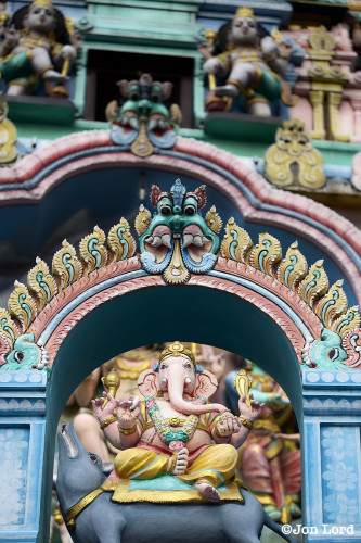 A Colour Photo In Portrait Format Of The Ornate, Colourful Decorated Facade Containing Small Statues (Murtis) Of Religious Deities Above The Entrance To The Hindu Sri Layan Sithi Vinayagar Temple In Singapore. 2012