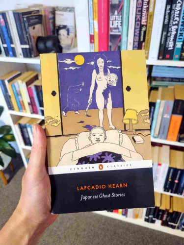 Holding up a copy of Lafcadio Hearn's Japanese Ghost Stories
