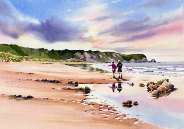 A walk on a sandy beach with the sea on the right and a rocky and grassy headland in the distance. The couple are reflected in the wet sand and water on the beach, and several rocks are visible on the beach.