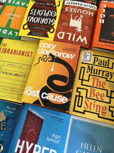 A table full of books with Cory Doctorow’s latest on it.