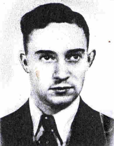 A portrait ID photo of the face of a young man with short hair. He is wearing a jacket, a shirt and a tie.