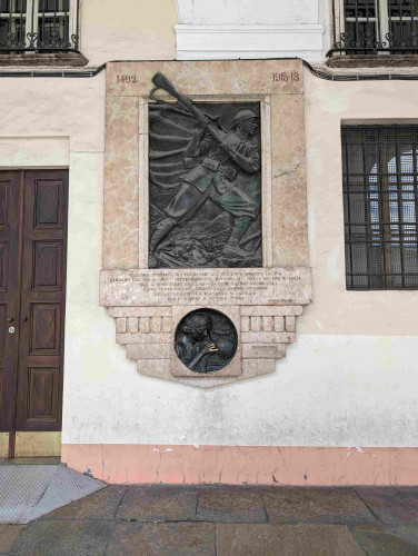 A bronze WWI memorial fresco set in a marble nook in a Turiese piazza. It features a protruding, beseeching hand. The fingers of the hand have been rubbed shiny by passers by. 