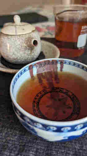 Red tea in a decorative cup.